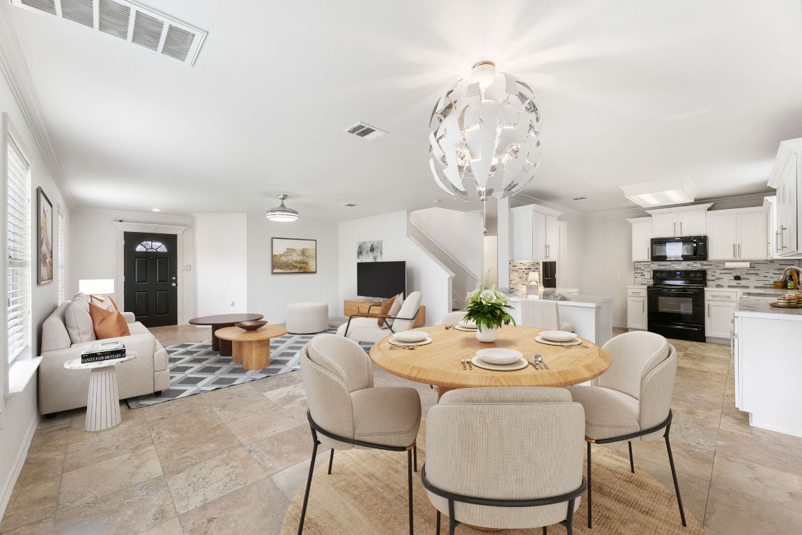 6828 Walkup Lane Austin, TX 78747 - Photo 1 of 1 a dining room with wooden floor a chandelier a wooden table and chairs