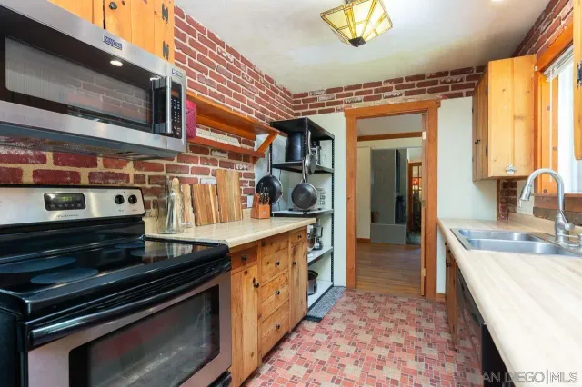 a kitchen with stainless steel appliances granite countertop a stove and a sink