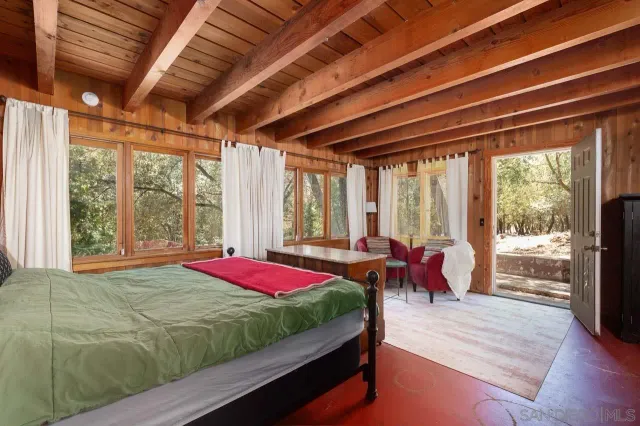 a bed room with a bed and a large window