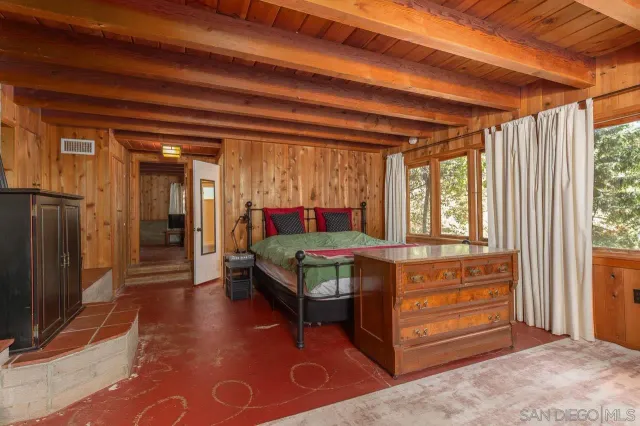 a bedroom with a bed chair and window