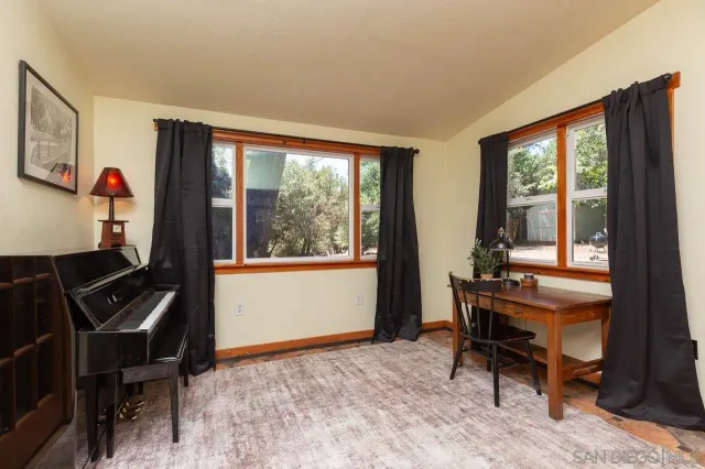 a view of a workspace with furniture and a window
