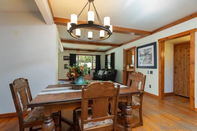 a view of a dining room with furniture wooden floor and chandelier