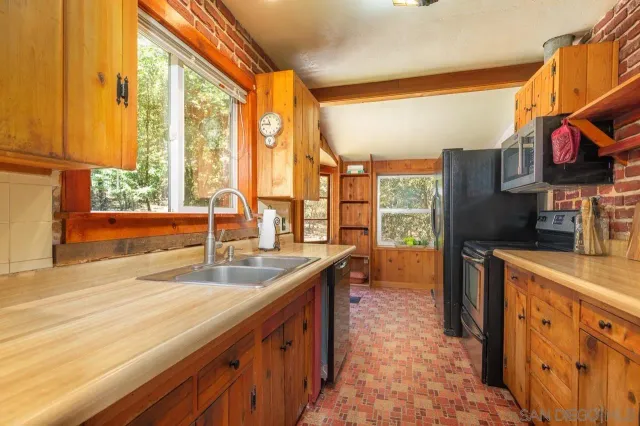 a kitchen with large windows and sink