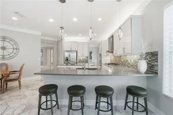 a kitchen with sink and view of living room