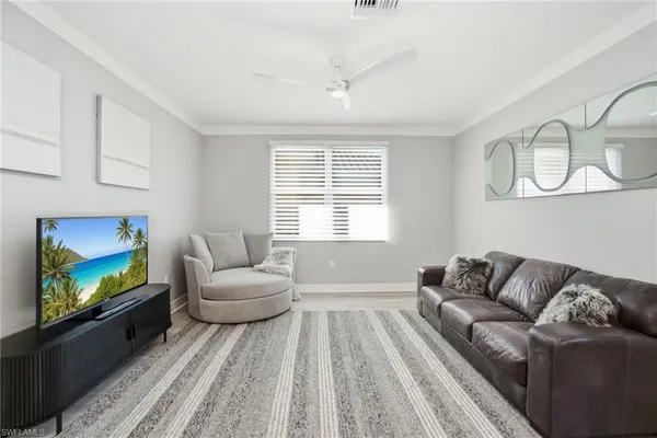 a bedroom with a large bed and wooden floor