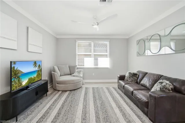 a bedroom with a large bed and wooden floor
