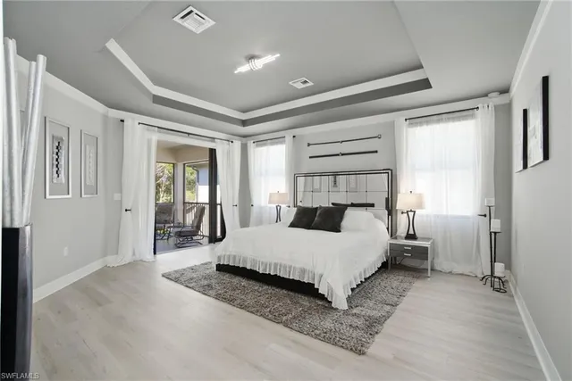 a bedroom with a bed and a large mirror