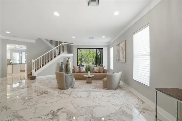 a very nice looking living room with a large window and potted plants