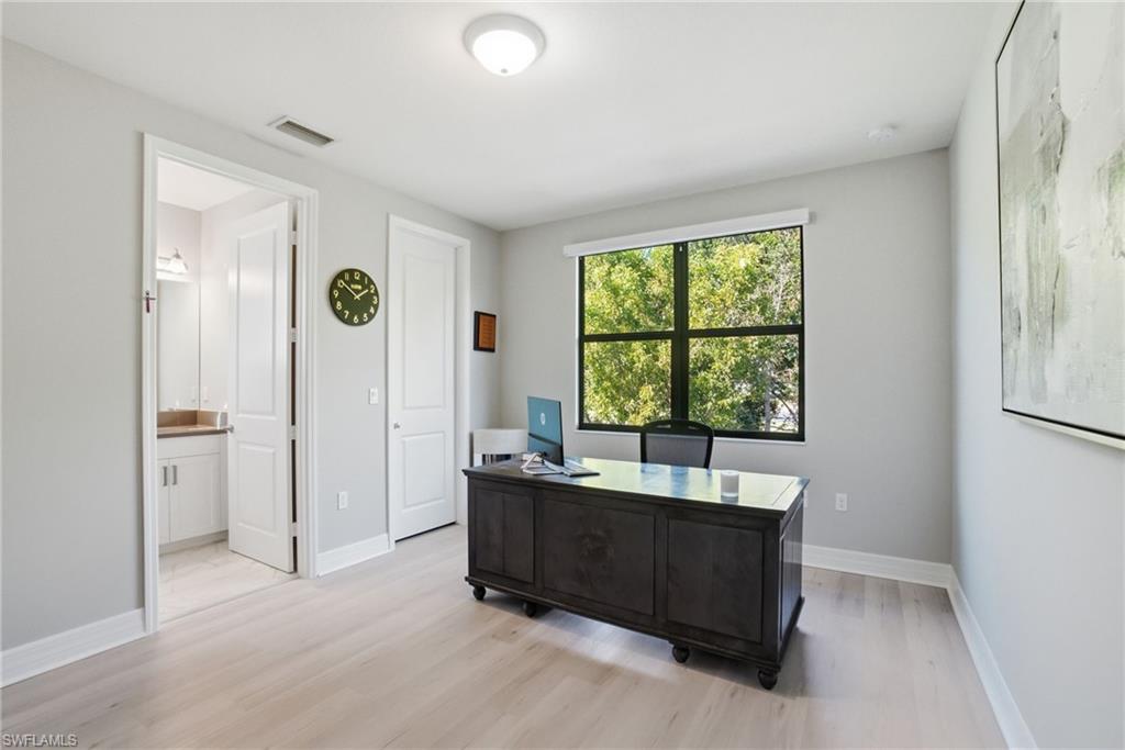4654 Kensington Circle Naples, FL 34119 - Photo 23 of 48 a living room with furniture and a large window