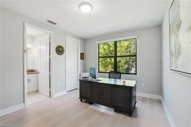 a bathroom with a sink vanity granite toilet and a mirror