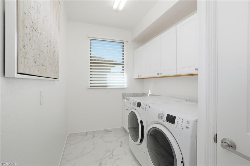 4654 Kensington Circle Naples, FL 34119 - Photo 26 of 48 a utility room with dryer and washer