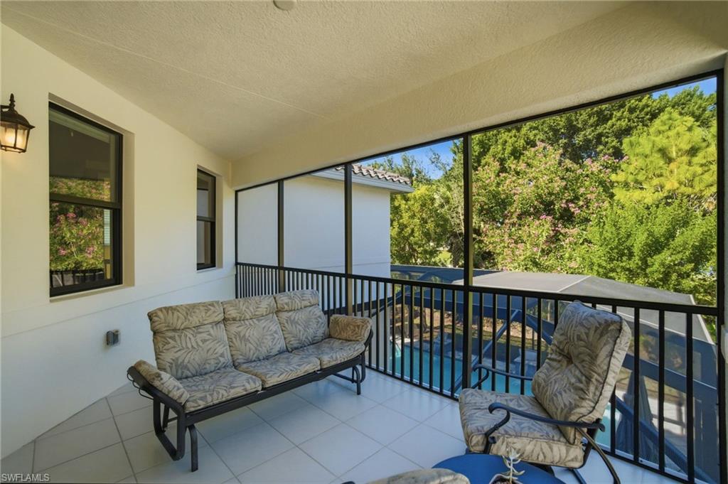 4654 Kensington Circle Naples, FL 34119 - Photo 29 of 48 a living room with furniture and a large window