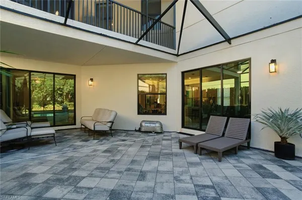 a aerial view of a house with a yard and potted plants