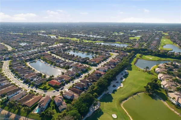 an aerial view of multi story residential apartment building with green space