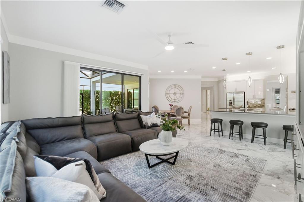 4654 Kensington Circle Naples, FL 34119 - Photo 5 of 48 a living room with furniture and a large window