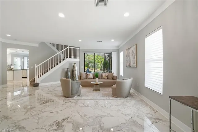 a very nice looking living room with a large window and potted plants