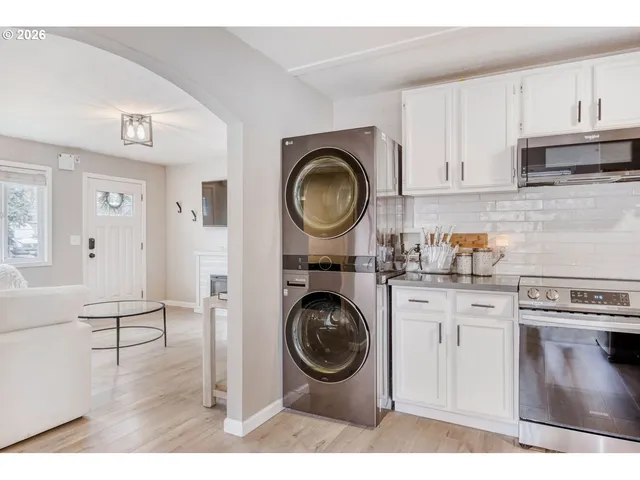 a kitchen with a stove top oven and cabinets