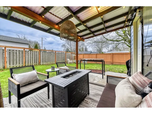 a view of a patio with a table and chairs