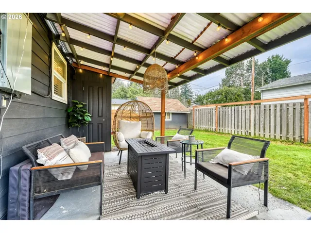a outdoor living space with furniture and a grill