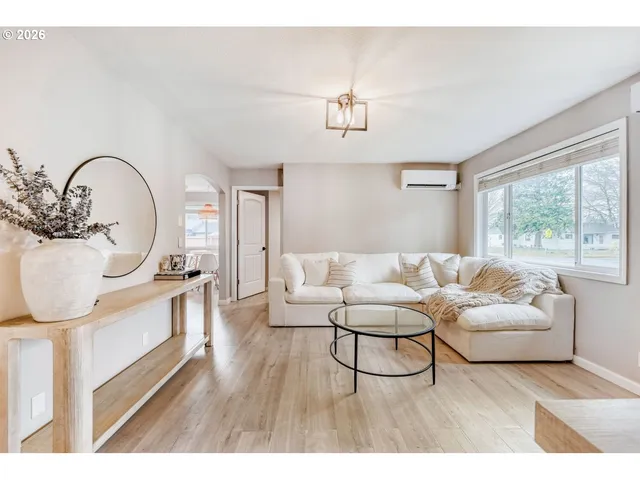 a living room with furniture a bathtub and a chandelier