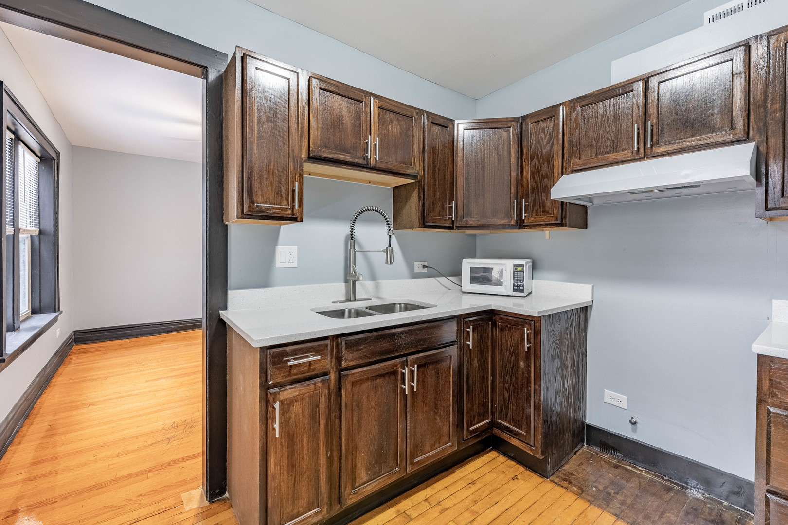 5805 South Whipple Street, Unit 1 Chicago, IL 60629 - Photo 2 of 15 a kitchen with a sink cabinets and appliances