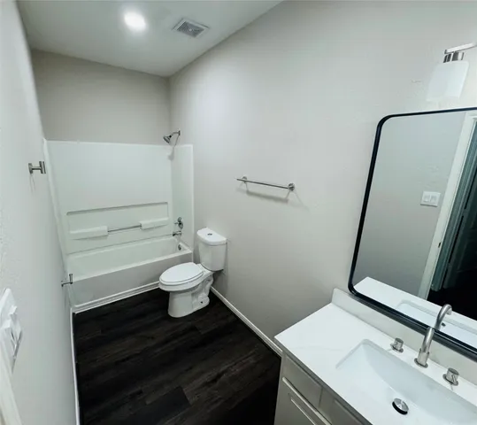 a bathroom with a sink a toilet and mirror