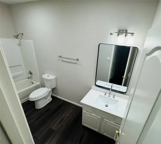 a bathroom with a sink toilet and mirror