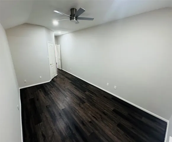 a view of an empty room and wooden floor