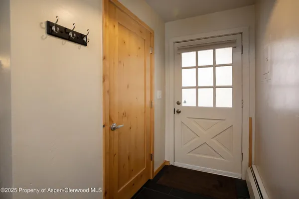 a kitchen with a refrigerator a stove a sink and white cabinets with wooden floor