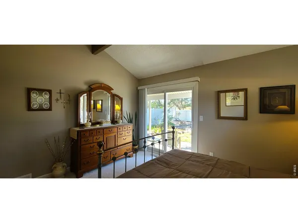 a bedroom with a bed and a dresser with mirror