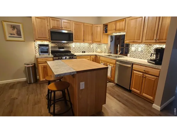 a kitchen with a sink a microwave a stove and refrigerator