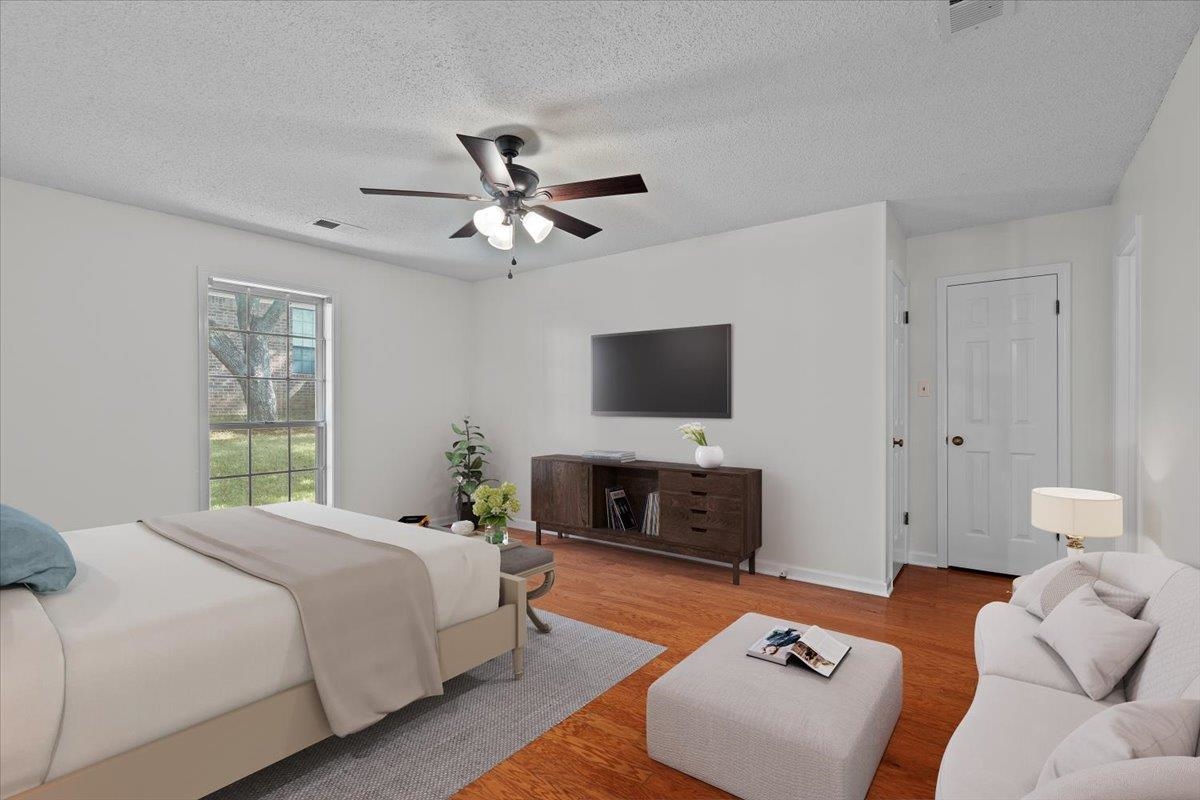 369 Taraview Road Collierville, TN 38017 - Photo 18 of 34 a spacious bedroom with a bed a flat screen tv and a fireplace