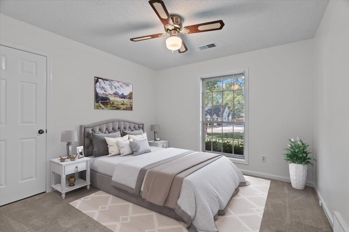 369 Taraview Road Collierville, TN 38017 - Photo 20 of 34 a bedroom with a large bed and a potted plant