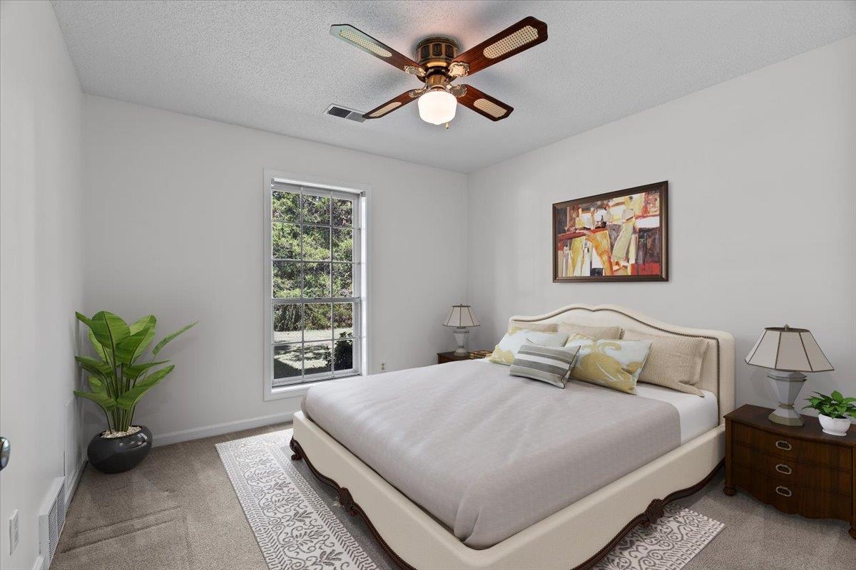 369 Taraview Road Collierville, TN 38017 - Photo 23 of 34 a bedroom with a bed and a potted plant