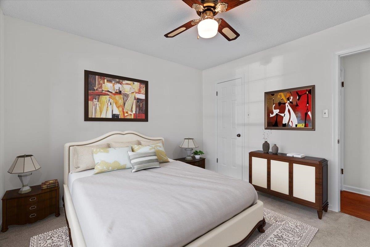 369 Taraview Road Collierville, TN 38017 - Photo 24 of 34 a bedroom with a bed and a chandelier