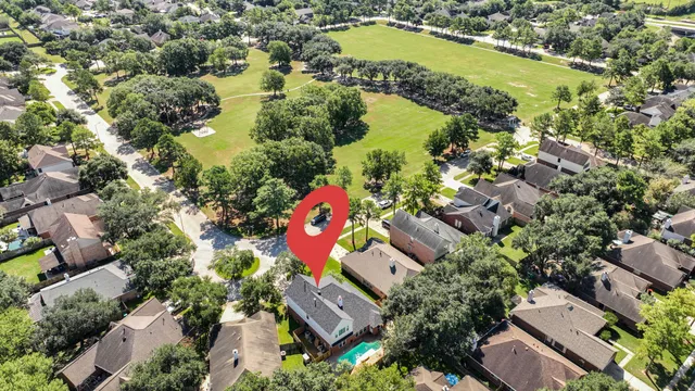 an aerial view of residential houses with outdoor space and lake view