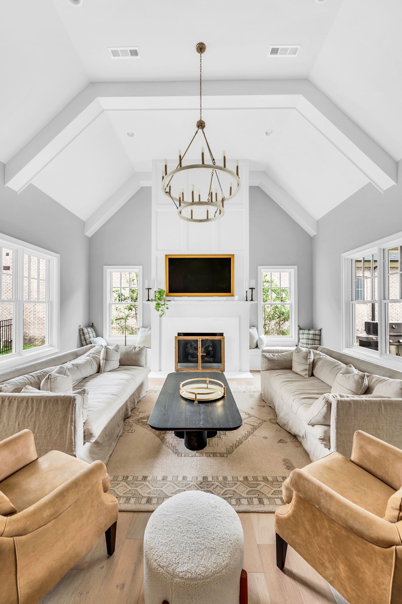 6081 Pasquo Road Nashville, TN 37221 - Photo 15 of 70 a living room with furniture a fireplace and a chandelier