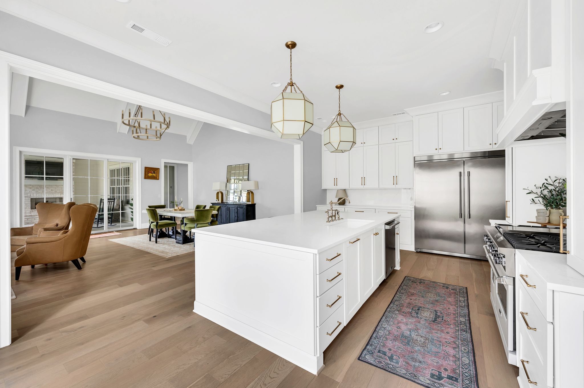 6081 Pasquo Road Nashville, TN 37221 - Photo 18 of 70 a large white kitchen with a large counter top and stainless steel appliances