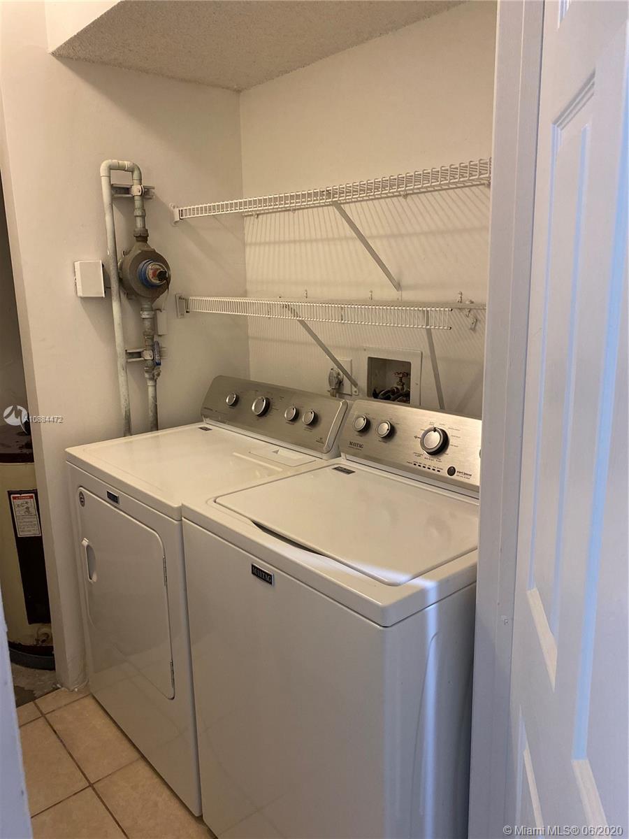 8741 Wiles Road, Unit 204 Coral Springs, FL 33067 - Photo 11 of 22 a utility room with dryer and washer