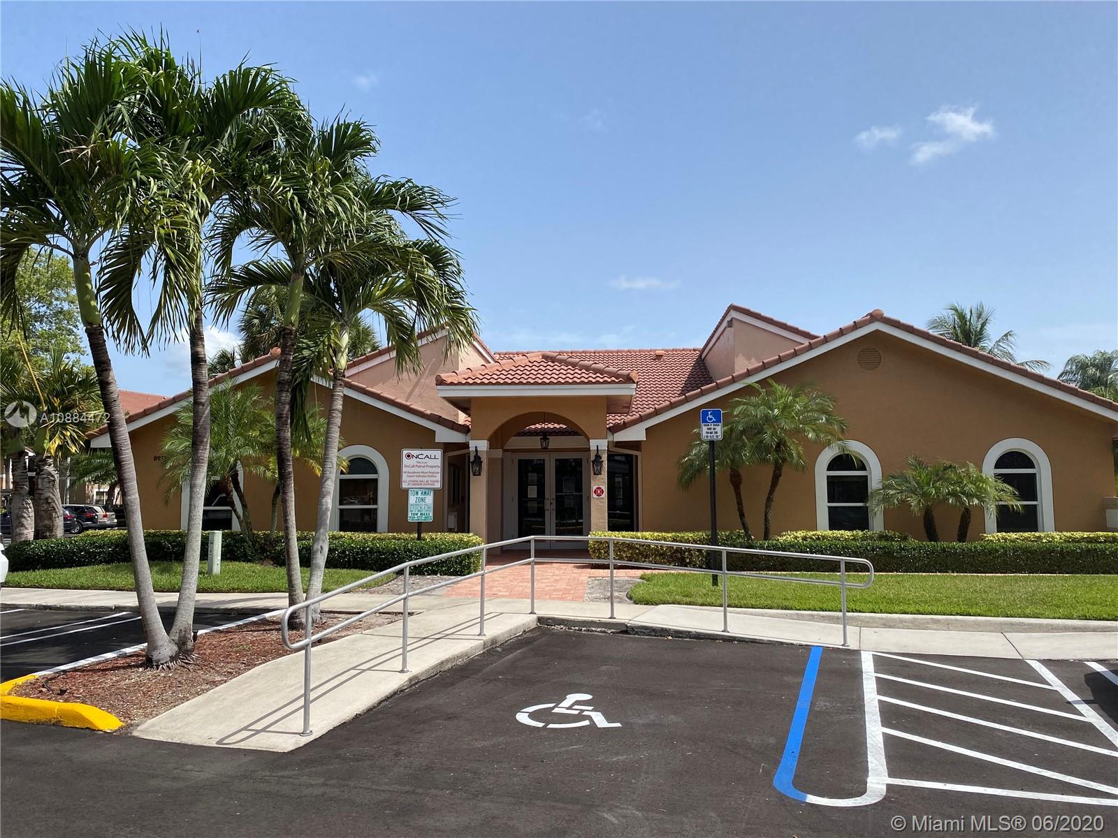 8741 Wiles Road, Unit 204 Coral Springs, FL 33067 - Photo 15 of 22 a view of a house with a big yard and large tree