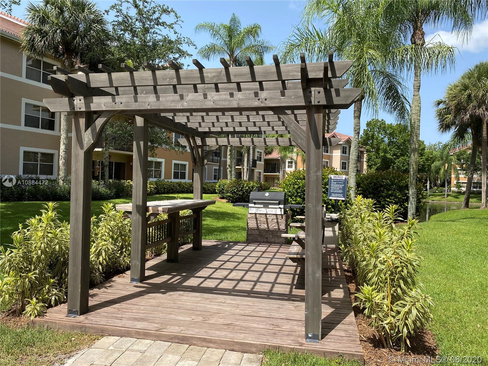 8741 Wiles Road, Unit 204 Coral Springs, FL 33067 - Photo 18 of 22 a view of a chairs and table in the patio