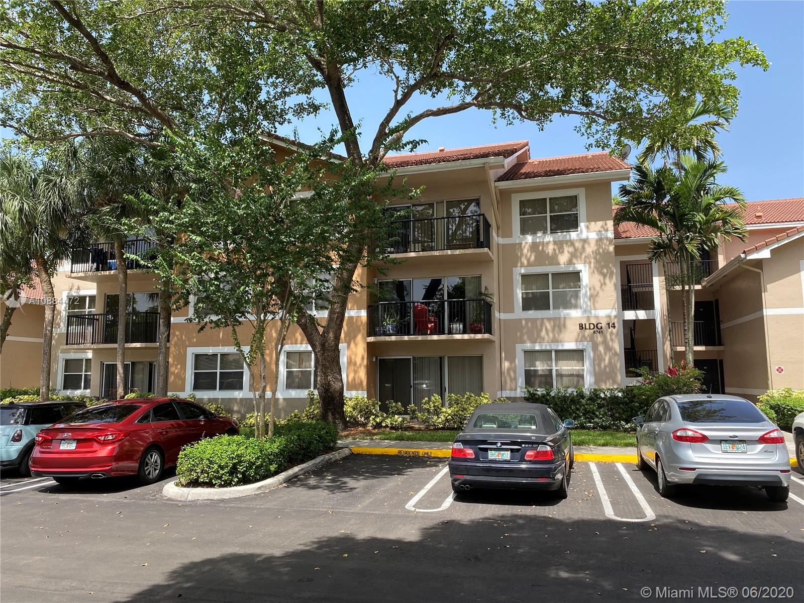 8741 Wiles Road, Unit 204 Coral Springs, FL 33067 - Photo 21 of 22 a houses view and a car parked in front of a house