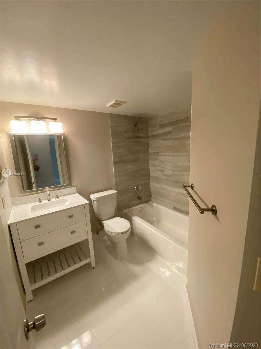 8741 Wiles Road, Unit 204 Coral Springs, FL 33067 - Photo 5 of 22 a bathroom with a sink a toilet and shower