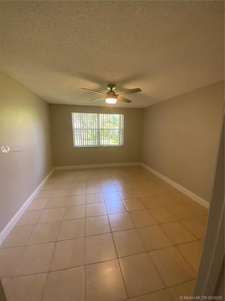 8741 Wiles Road, Unit 204 Coral Springs, FL 33067 - Photo 6 of 22 a view of an empty room with a window