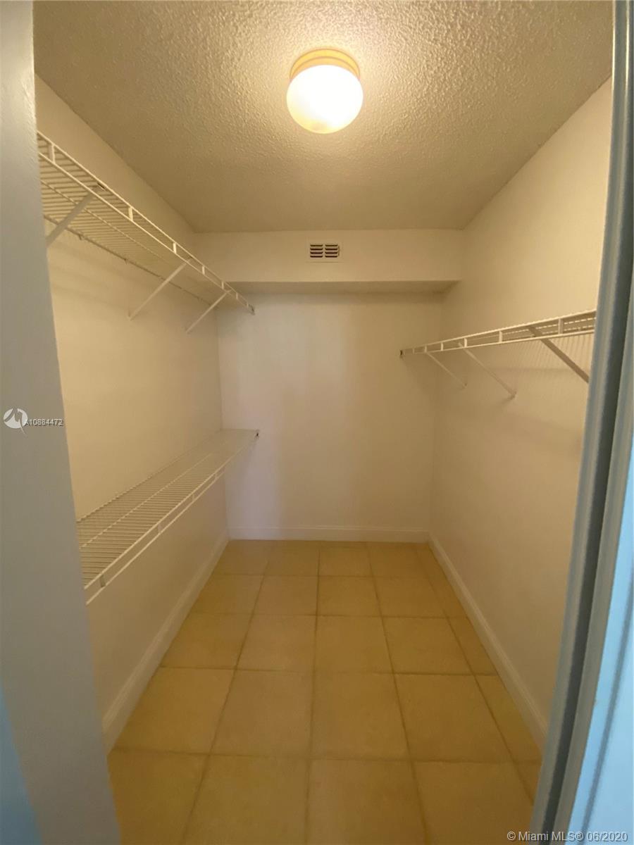 8741 Wiles Road, Unit 204 Coral Springs, FL 33067 - Photo 7 of 22 a view of a room with racks on the wall