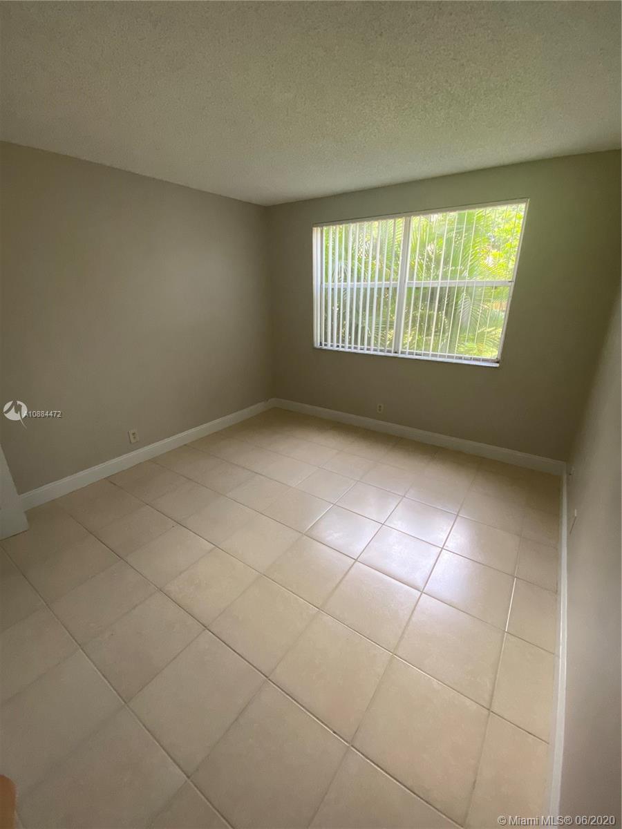 8741 Wiles Road, Unit 204 Coral Springs, FL 33067 - Photo 9 of 22 a view of an empty room with a window