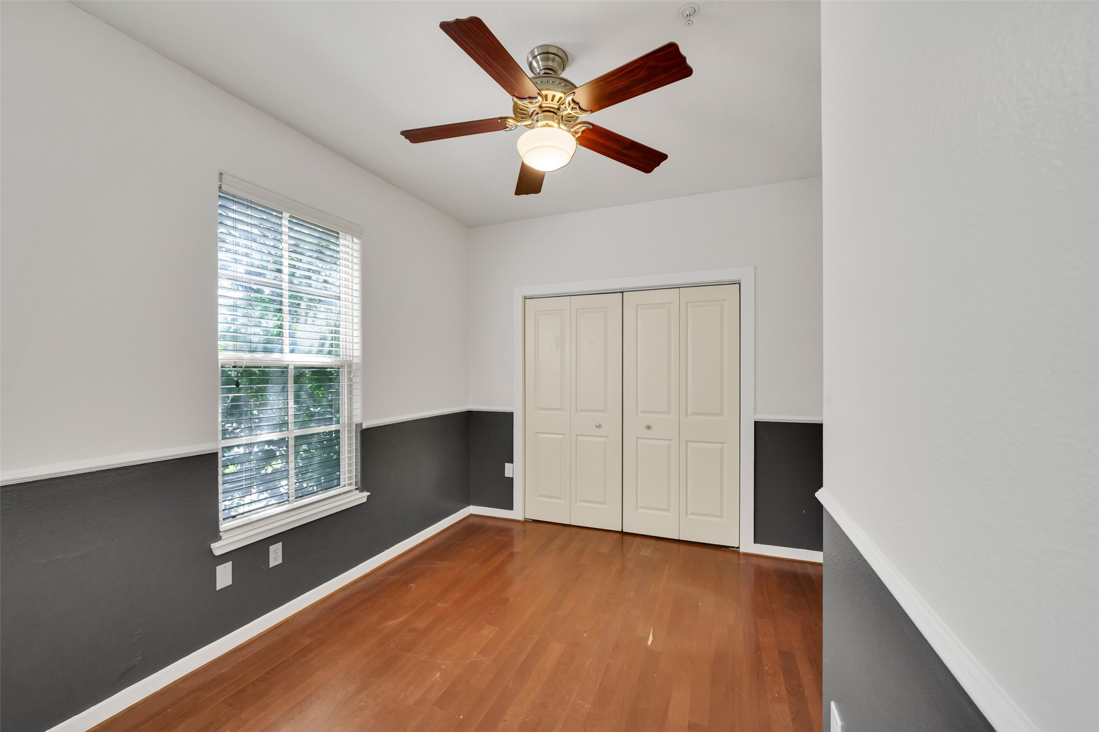 2216 Chenevert Street, Unit 6 Houston, TX 77003 - Photo 14 of 29 a view of an empty room with wooden floor and a window