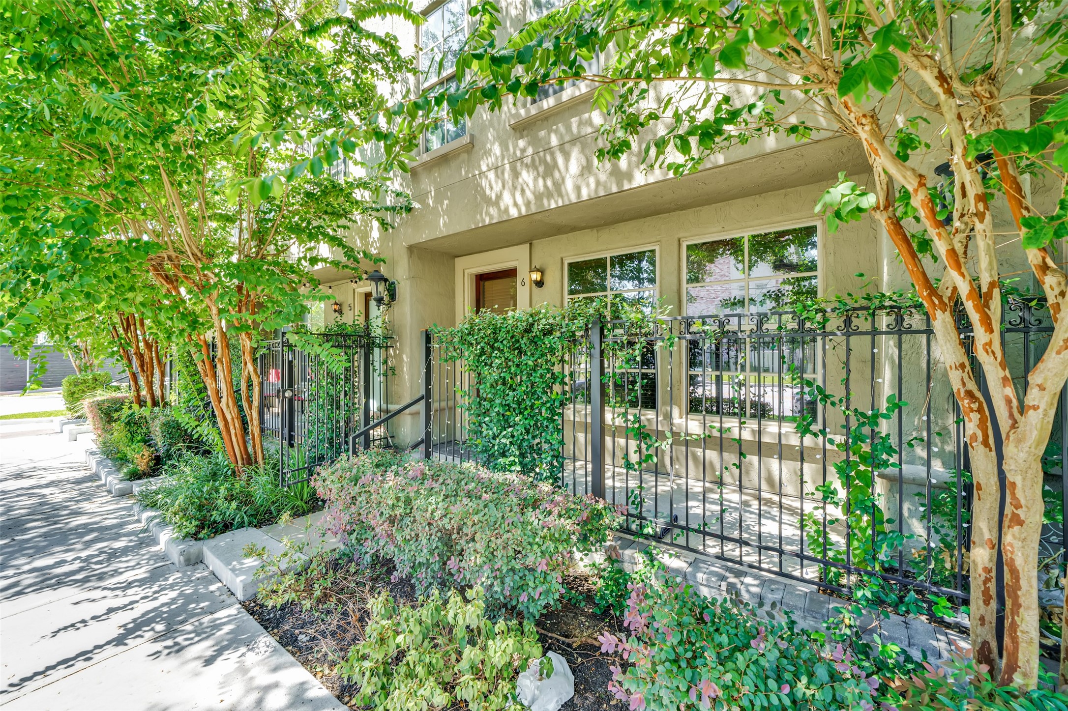 2216 Chenevert Street, Unit 6 Houston, TX 77003 - Photo 16 of 29 a view of a garden with plants and large trees