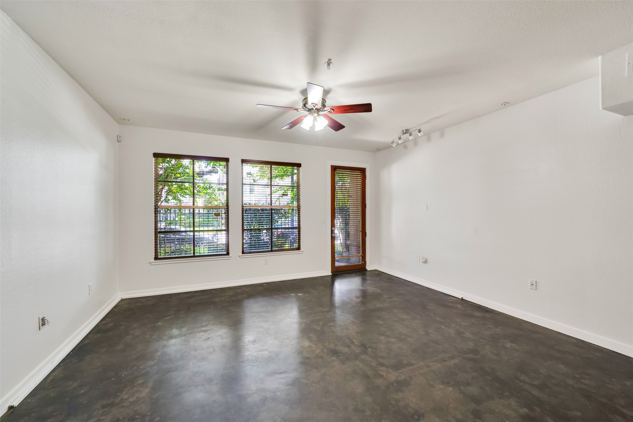 2216 Chenevert Street, Unit 6 Houston, TX 77003 - Photo 5 of 29 an empty room with chandelier fan and windows