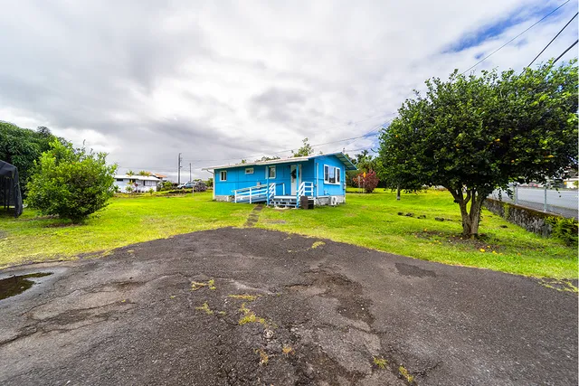 a view of a house with a yard and swimming pool